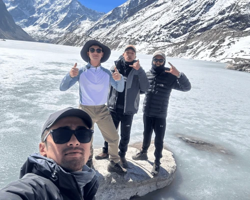 Trekkers At Glacial Lake